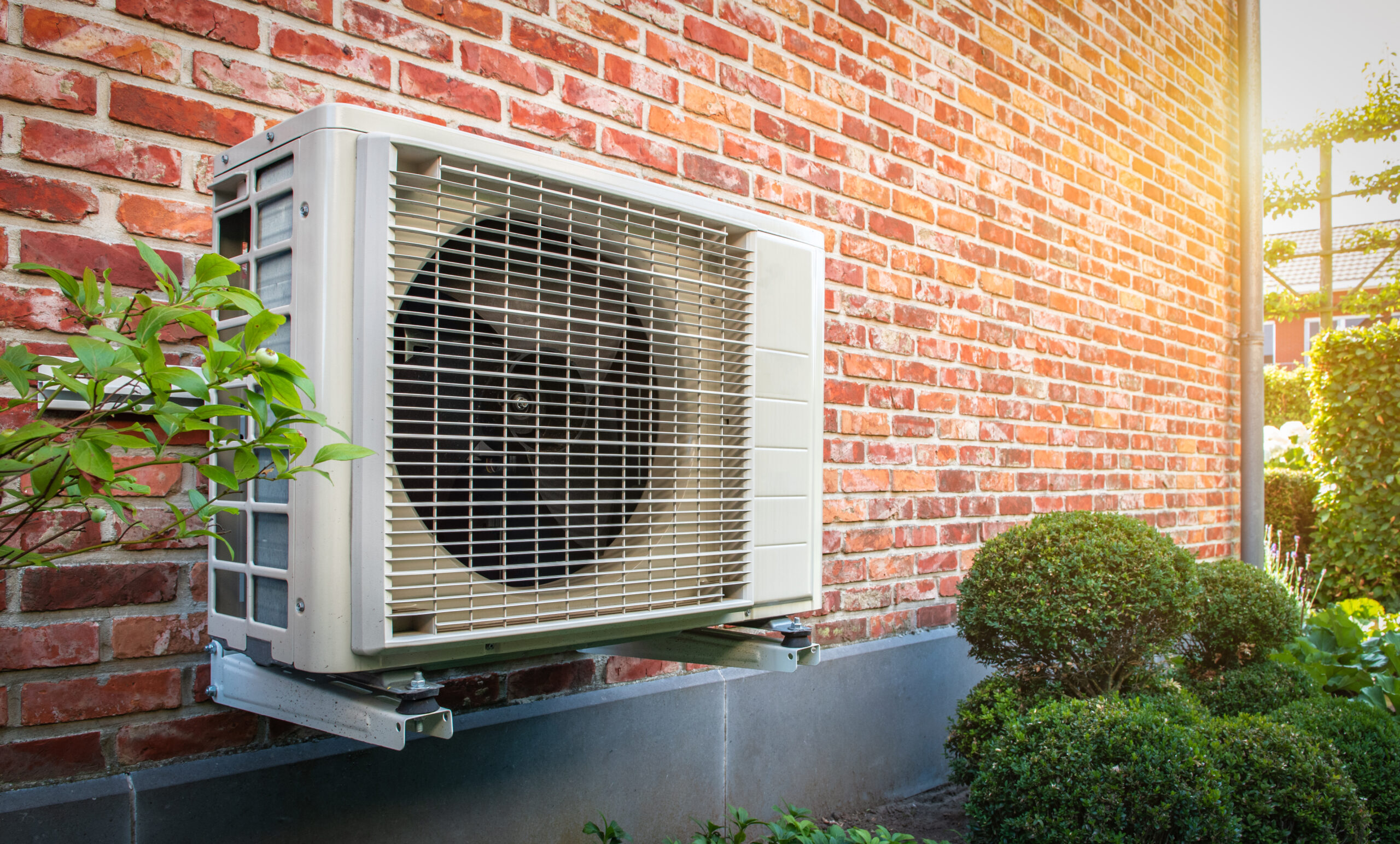 Heat pump mounted on the brick wall of an Ohio residence