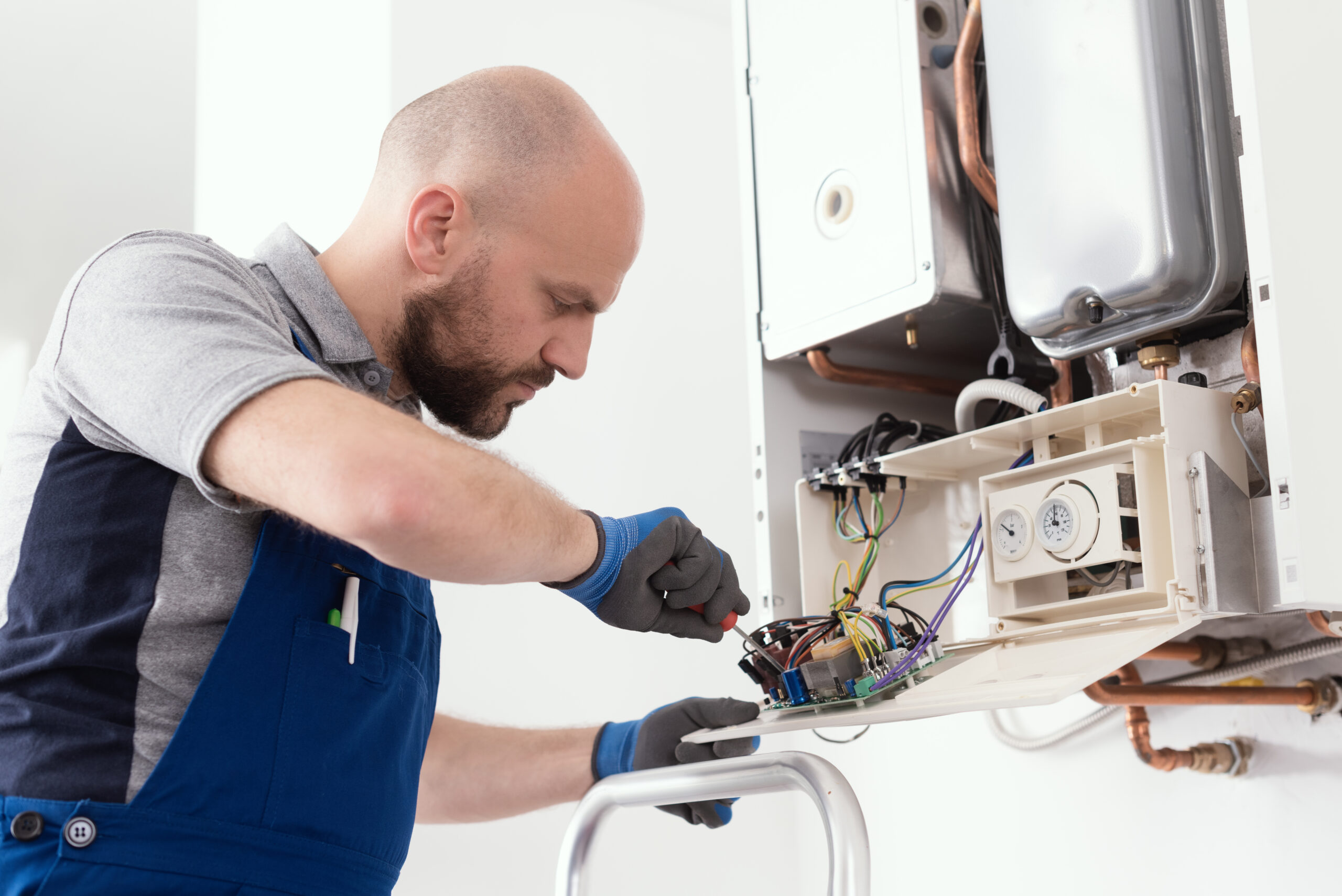 HVAC technician performing a maintenance service on a heating system