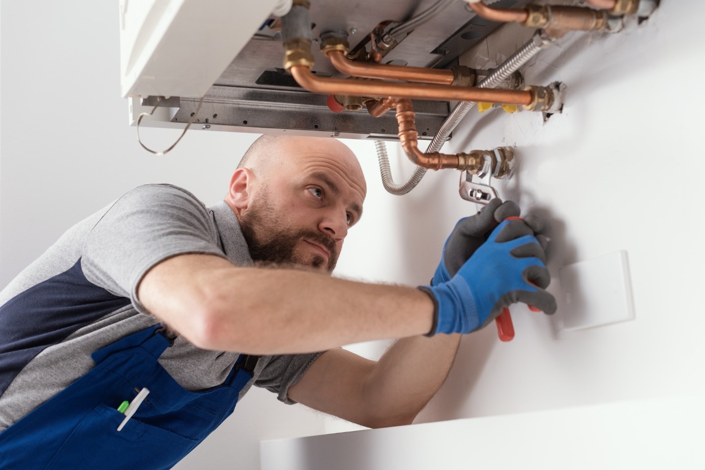 HVAC technician performing a repair service on a residential boiler