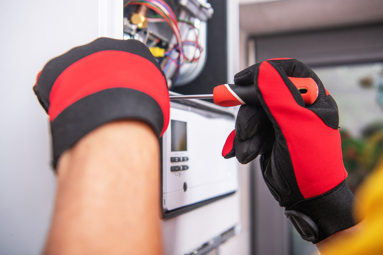 A technician repairing a heating unit