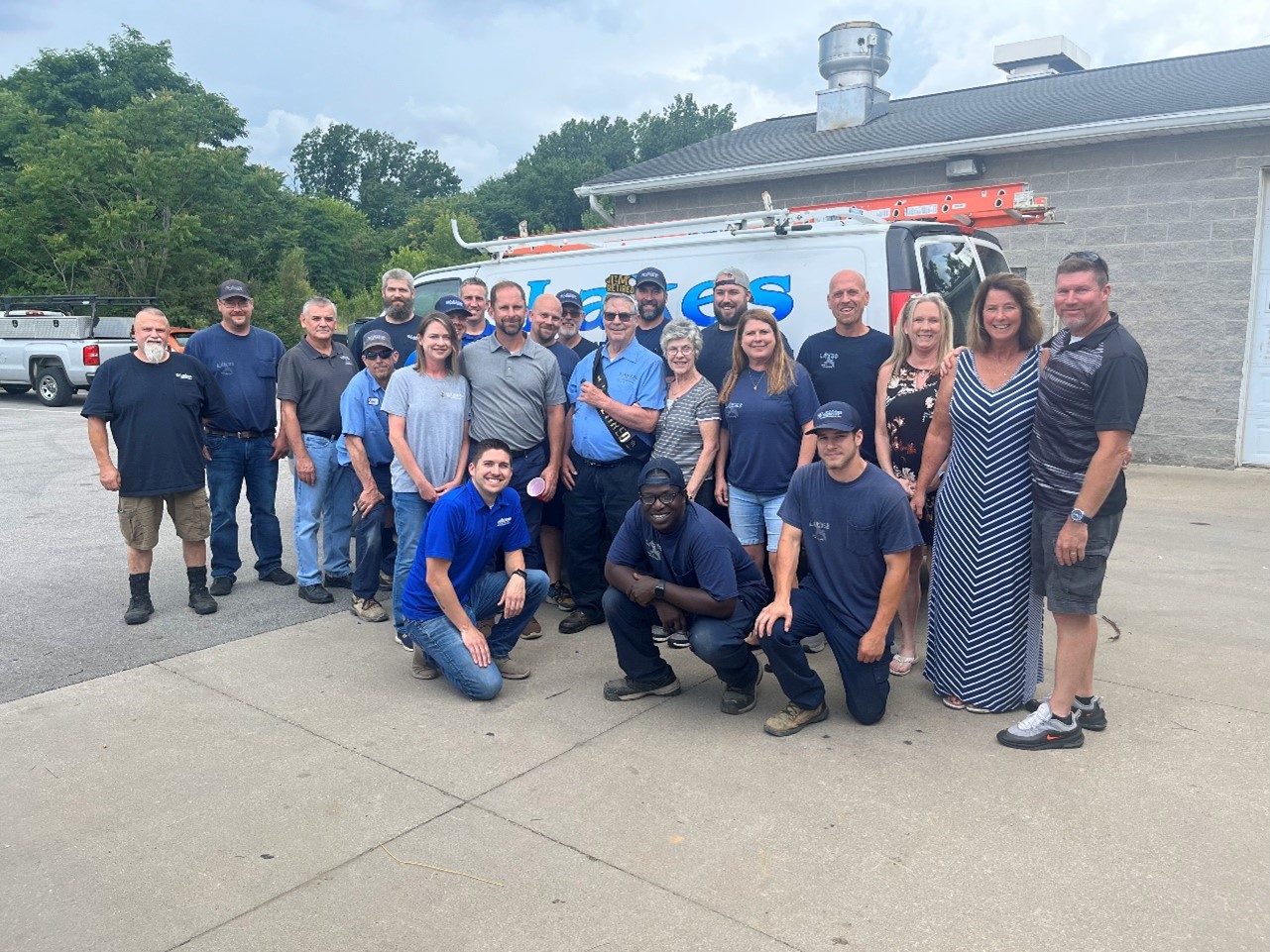 Lakes Heating & Air Conditioning team standing in front of a work truck