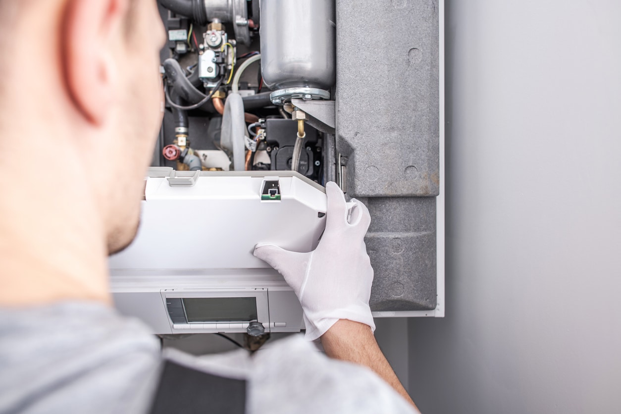 HVAC technician repairing a residential furnace