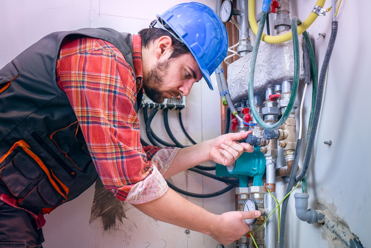 HVAC technician checking commercial heating system