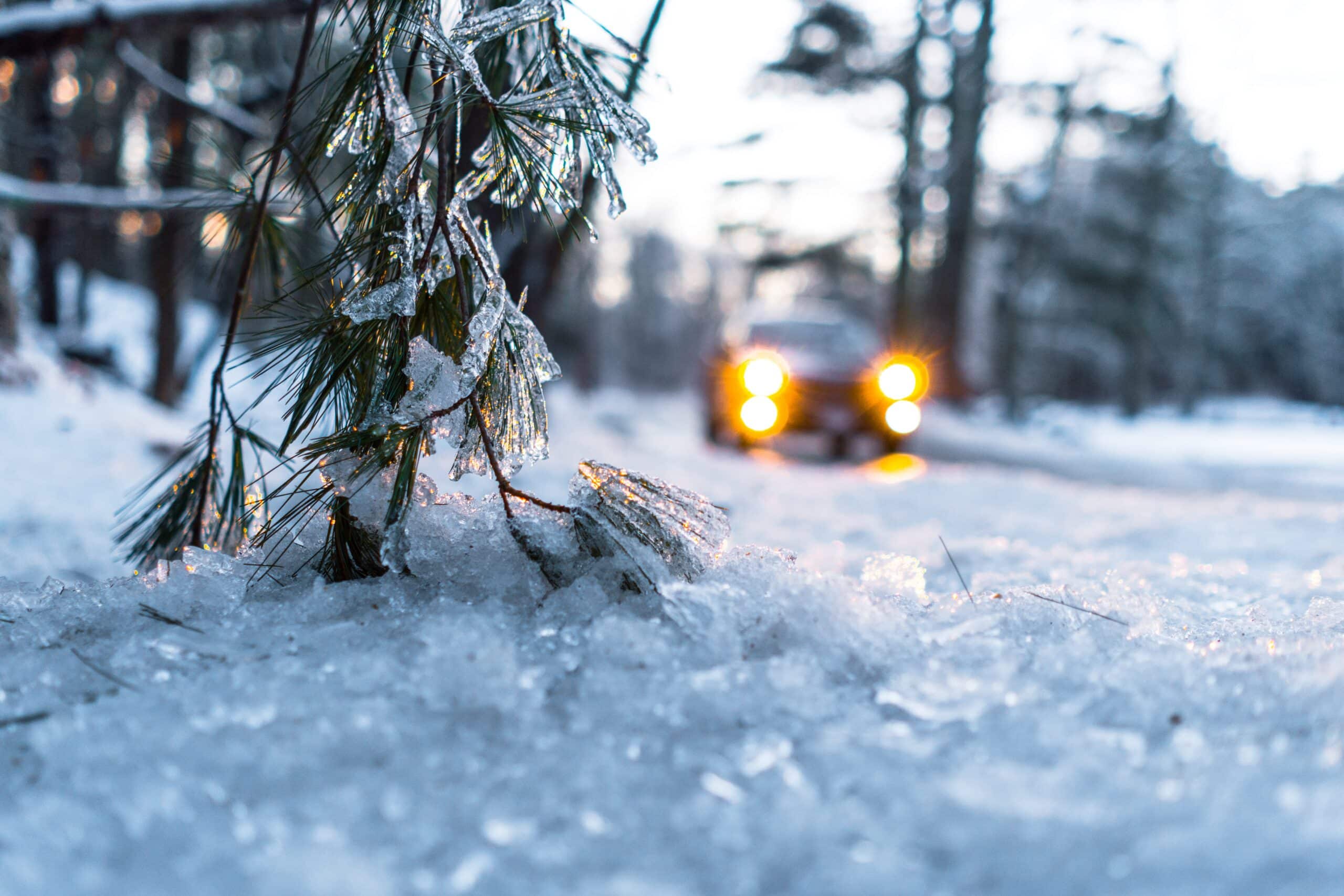 Snow on a driveway with a car on it