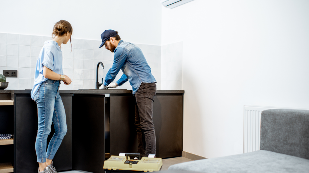 Plumber installing faucet in Akron